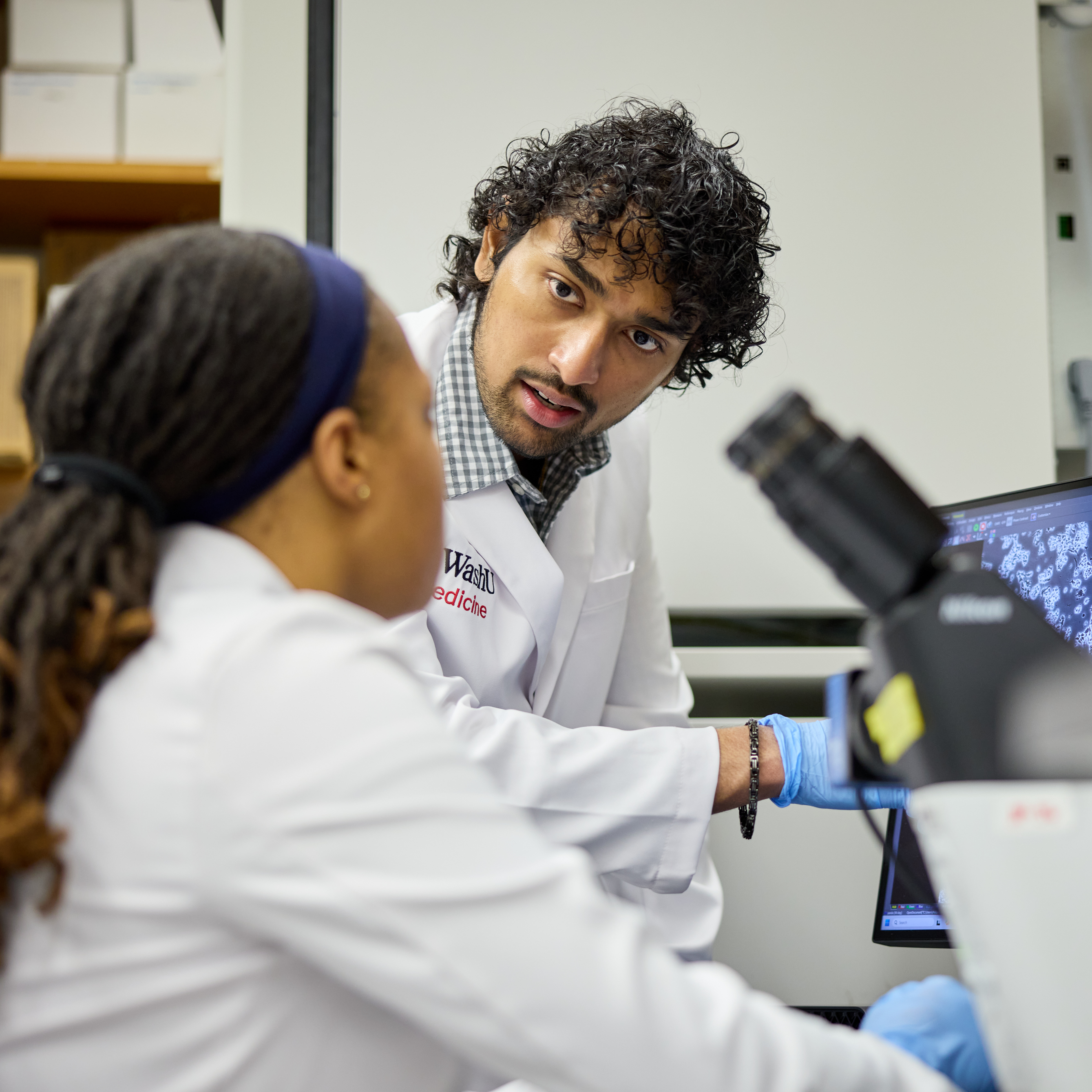 DBBS student Sharvath Kathi (with beard) and research technician Jalalah Muhammad work in the research lab of Jennifer Philips, MD, PhD, at MPRB on May 7, 2025.