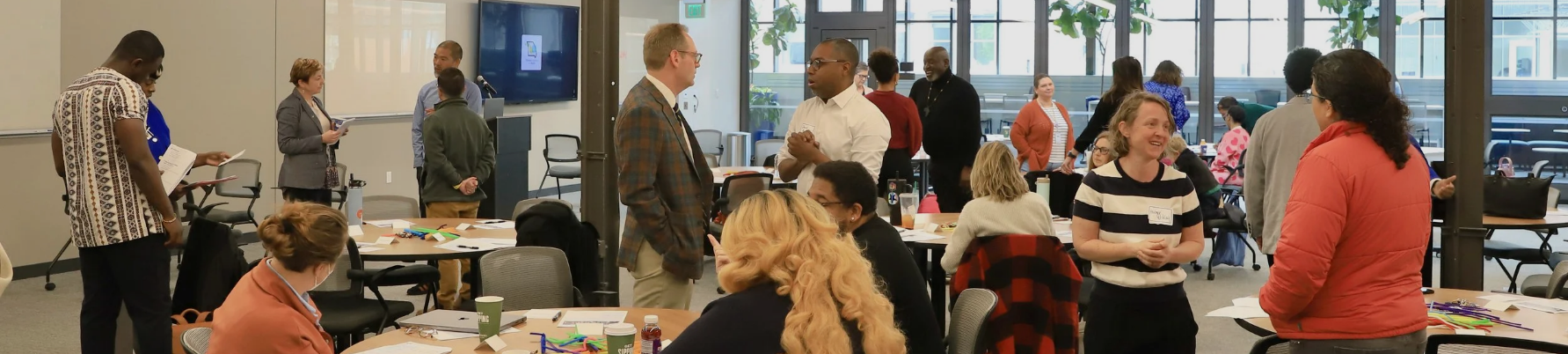 Conference attendees, including WashU Medicine Infectious Diseases faculty, discussing topics at Midwest HIV Response & Action Summit in 2025.