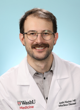 Justin Klucher, MD in WashU doctor's white coat